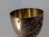 a silver cup that is sitting on a table