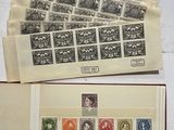 two books with stamps on them sitting next to each other on a table