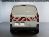 a white van with red and white stripes parked in a room