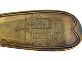 a gold spoon with a coat of arms and a coat of arms on it
