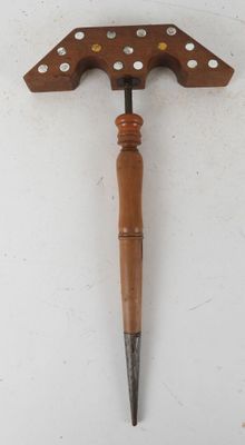 a close up of a wooden handle with holes on it