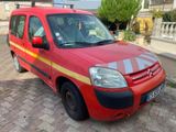 a red van that is parked on the side of the road