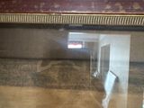 a reflection of a car in a mirror on the floor