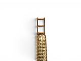 a gold clock that is hanging on a wall