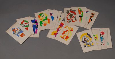 many cards with different designs on them sitting on a table