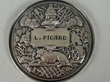 a silver coin with a picture of a bear on it