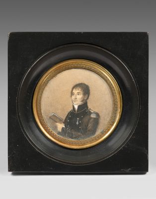 portrait of a young man in a black coat holding a book