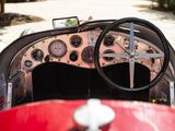 a steering wheel and dashboard of a red car
