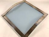 a close up of a square glass plate on a white surface