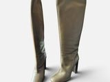 pair of women ' s high heel boots on a white background
