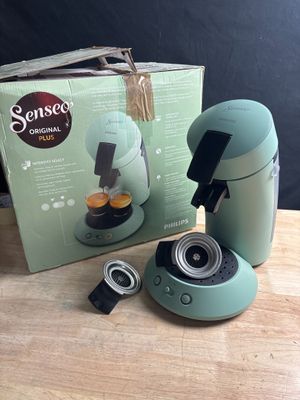 a box with a coffee maker next to it on a table