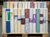 many rolls of fabric on a pallet in a warehouse