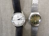 two watches sitting next to each other on a table