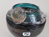 a glass jar with a lid on a white surface