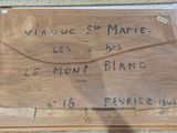 a wooden box with writing on it sitting on a table