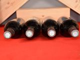 several bottles of wine are lined up in a row on a table