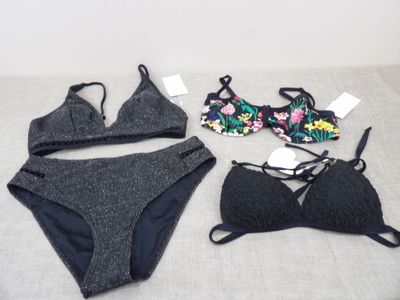 two pieces of underwear are laying on a bed next to each other