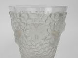 a clear glass vase with a flower design on it