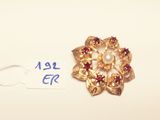 an image of a gold brooch with garnets and pearls