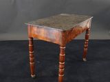 a small table with a marble top and wooden legs