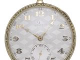 a gold pocket watch with roman numerals on the face