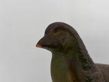 a statue of a duck that is sitting on a table