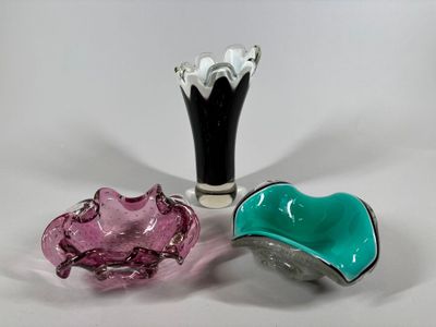 three glass vases sitting next to each other on a table