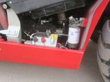 a small engine in the back of a red truck