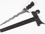 a knife that is laying on top of a piece of metal