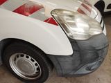 a white van with red and white stripes parked in a garage