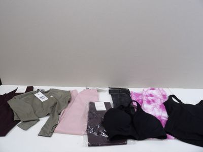 a lot of clothes that are on a white table
