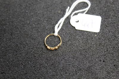 a close up of a gold ring with a tag on it