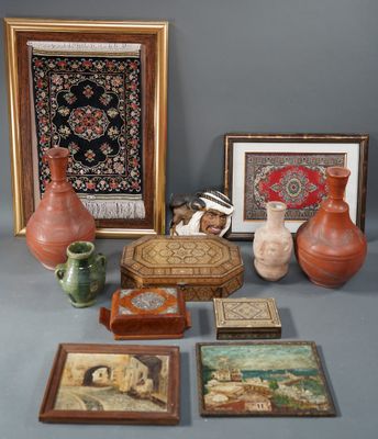 many different pieces of art displayed on the table