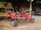 an image of a tractor and a farm equipment in a barn