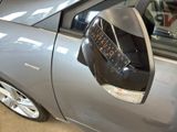 a car with a parking meter attached to the side of it