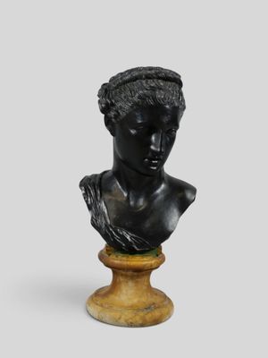 a black busturine of a woman wearing a headband