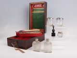 three bottles and a box of glass on a table