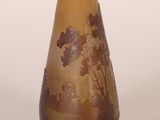 a brown vase with a tree design on it