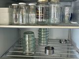 an open refrigerator with a lot of glass jars on the shelves