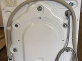 a white washer sitting in the middle of a room