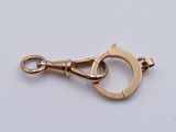 a close up of a gold plated metal clasp on a white background