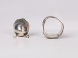 silver ring with a shell on it and a silver ring with a shell on it