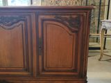 a wooden cabinet that is sitting in the middle of a room