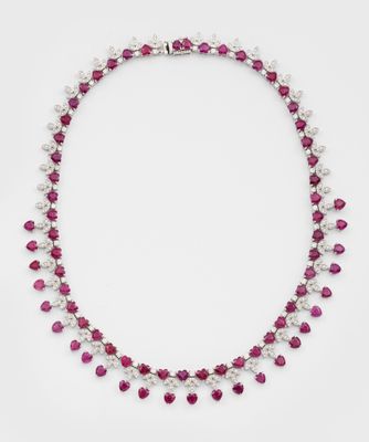 a ruby and pearl necklace with pearls on a white background