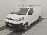 the white van is parked in a clean room with checkered flooring
