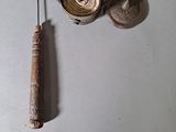 a small metal object next to a small metal object on a table