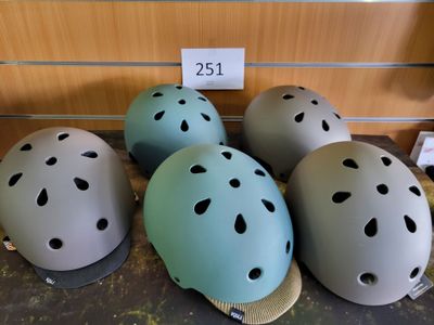 four helmets are lined up on a table with a price tag
