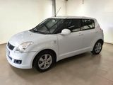 the small white car is parked in a large room