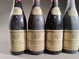 four bottles of wine are lined up on a table