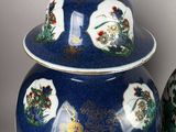 two blue and white vases sitting next to each other